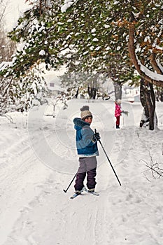 Kid skiing in a winter forest