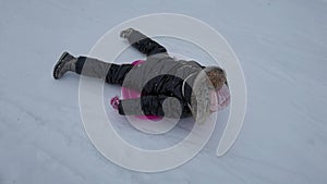 Kid Sledding in Snow, Child Playing in Winter, Little Girl Sledging Outdoor in Park