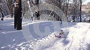 Kid Sledding in Snow, Child Playing in Winter in Park, Girl at Sledding in Skiing Sport Resort, Children Sledging in Mountains