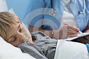 Kid sleeping in hospital bed