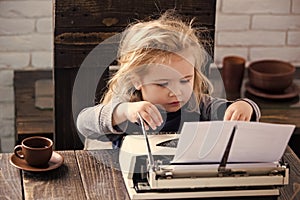 Kid or small boy or businessman child with typewriter