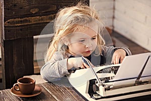 Kid or small boy or businessman child with typewriter