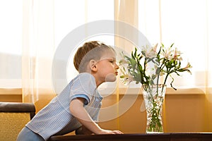Kid smells a bouquet