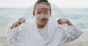 Kid, smile and happy with face at beach while showing, arm and muscles for competition, match or training for karate