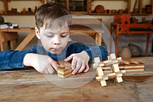 Kid solves wooden puzzle