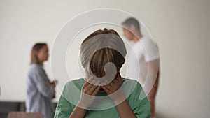 Kid son feels upset while parents fighting at background, sad little girl frustrated with psychological problem caused