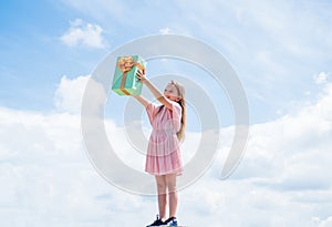 kid at store. smiling child with birthday gift. childhood happiness. pretty teenage girl outdoor. kid holiday shopping