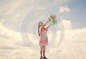 kid at store. smiling child with birthday gift. childhood happiness. pretty teenage girl outdoor. kid holiday shopping