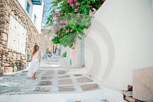 Kid at street of typical greek traditional village with white stairs on greek island