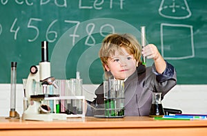 Kid study biology chemistry. Boy microscope and test tubes school classroom. Basic knowledge primary school education