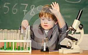 Kid study biology and chemistry in school. School education. Explore biological molecules. Toddler genius baby. Boy near