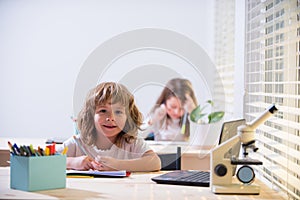 Kid studying at school. Schoolchild doing homework at classroom. Education for kids.