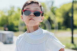 Kid in sunglasses looking at camera