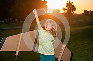 Kid superhero with jetpack. Child pilot play on summer day at sunset. Success, leader and winner concept. Kids
