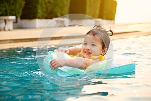 Kid swim in the swimming pool on summer holiday. Asian little girl lifestyle