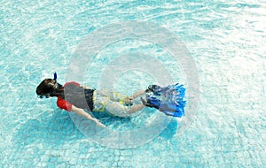 Kid swimming in the pool