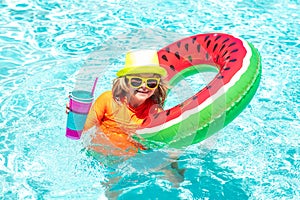 Kid in swimming pool, relax swim on inflatable ring and has fun in water on summer vacation. Children in the swimming