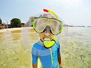 Kid in swimming suit snorkeling in the Indian Ocean