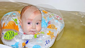 Kid swims with a decoction of grass in a circle around his neck