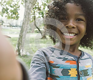 Kid taking selfie in park