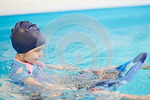 Kid with teacher learn to swim