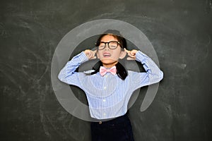 Kid teacher standing in chalkboard background