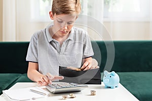 Kid teen boy counting money and taking notes, saving money in a piggy bank. Learning financial responsibility and