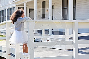 Kid toddler girl playing climbing a fence outdoor