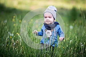 Kid toddler in grass, happy expression