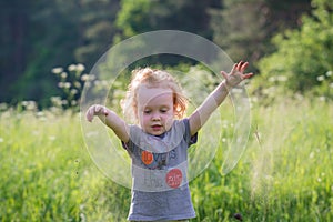 Kid toddler in nature playing near forest