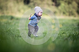 Kid toddler in park having fun running