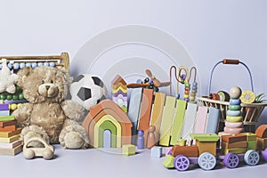 Kid toys collection isolated on blue background. Teddy bear, wooden, plastic and fluffy educational baby toy set. Front