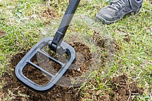 Kid treasure hunters metal detecting and digging the ground