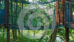 Kid in a treetop adventure park