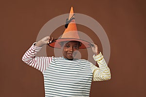 Kid Trying On Orange Wizard Hat