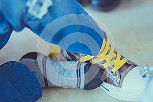 Kid is tying shoes laces before stage show