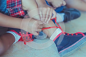 Kid is tying shoes laces before stage show