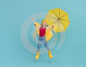 Kid with umbrella on colored background