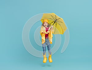 Kid with umbrella on colored background