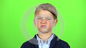 Kid is upset and sad. Green screen. Slow motion