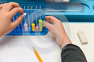 kid using abacus to show specified number