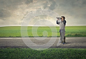 Kid using binoculars to contemplate