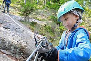 Kid using safety climbing equipment