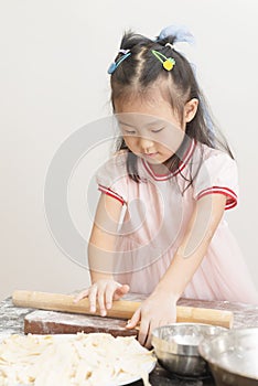 Kid using stick to make noodles