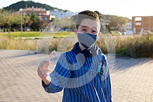 kid with a Valencian Fallas dress showing a wick to play with firecrackers photo