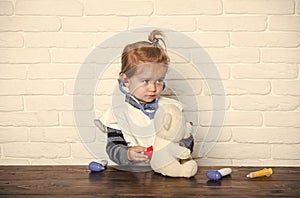 Kid veterinarian examine teddy bear with stethoscope