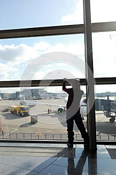 Kid waiting for boarding plane at airport