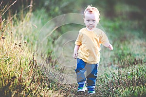 Kid walking in nature alone