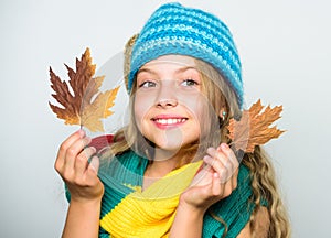 Kid wear warm knitted hat and long scarf. Fall fashion concept. Which fabrics will keep you warmest this autumn. Warm