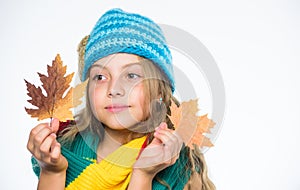 Kid wear warm knitted hat and long scarf. Which fabrics will keep you warmest this autumn. Warm woolen accessories. Girl